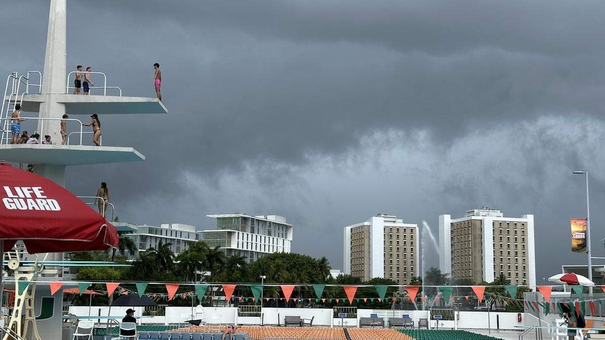 Kids attending University of Miami’s summer dive camp on Friday afternoon, June 14, 2024, get a few more leaps off the 10-meter diving tower at the University Center pool before the clouds burst and lightning detectors blared. Lifeguards cleared the pool, a frequent happenstance over the stormy week.