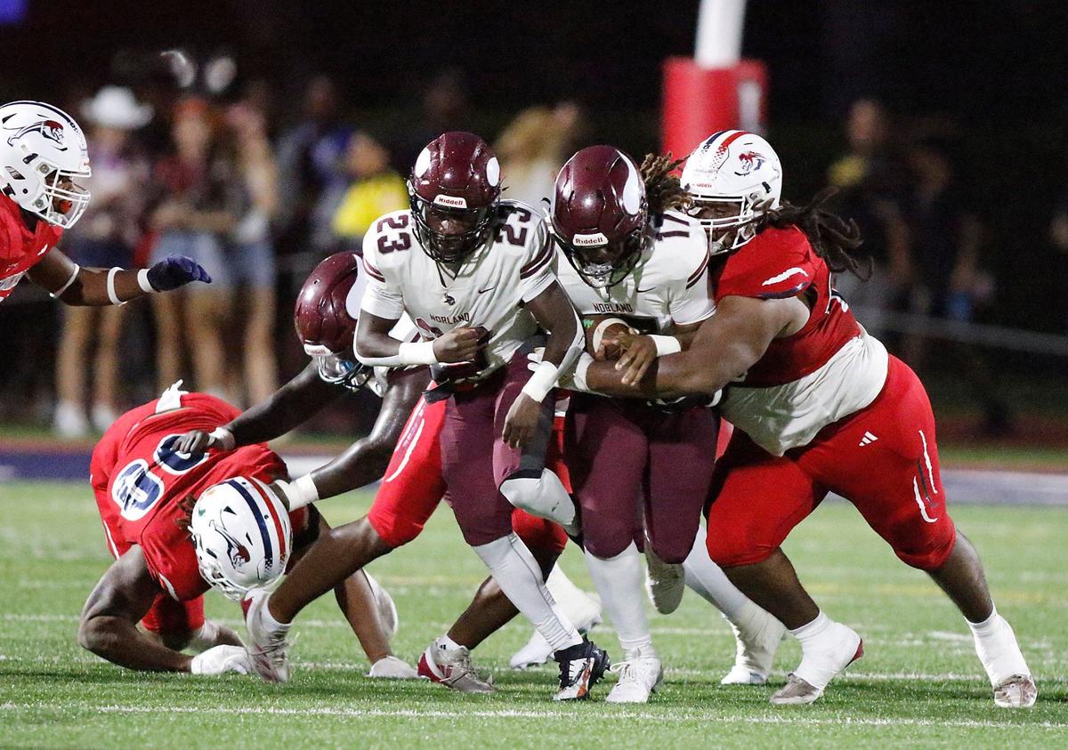 Chaminade-Madonna Lions defenders tackle Norland Vikings wide receiver EnnioYapoor during football game on Thursday, September 19, 2024 at Chaminade-Madonna HS in Hollywood. Andrew Uloza / for Miami Herald