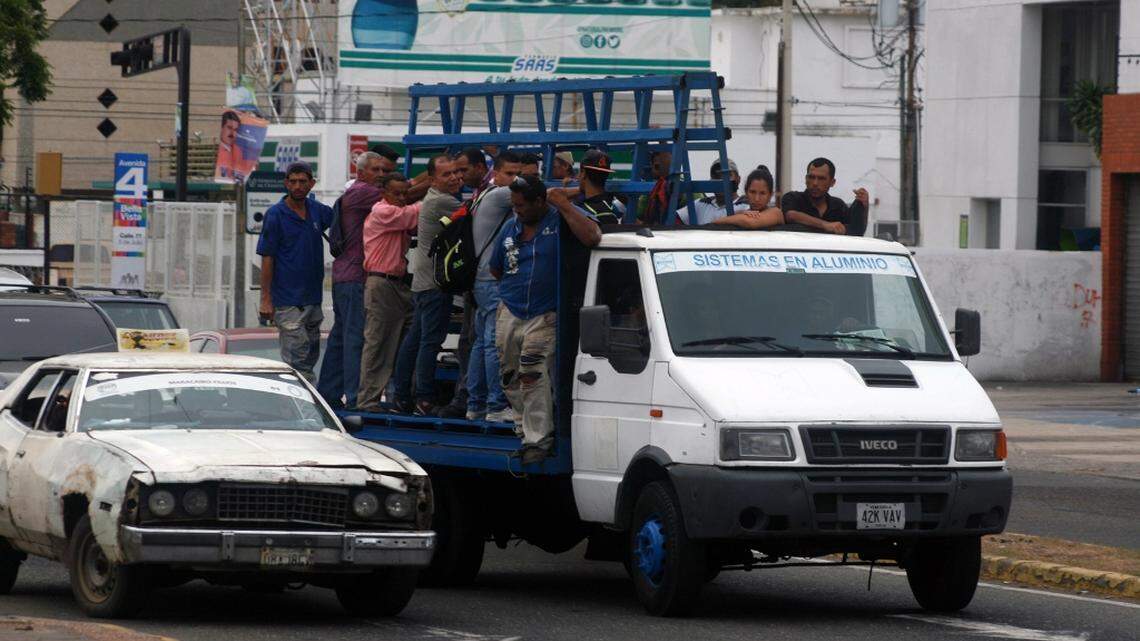 On a main street in Maracaibo, Venezuela, residents crowd onto illegal and dangerous vehicles nicknamed "kennels" for their unsafe conditions.