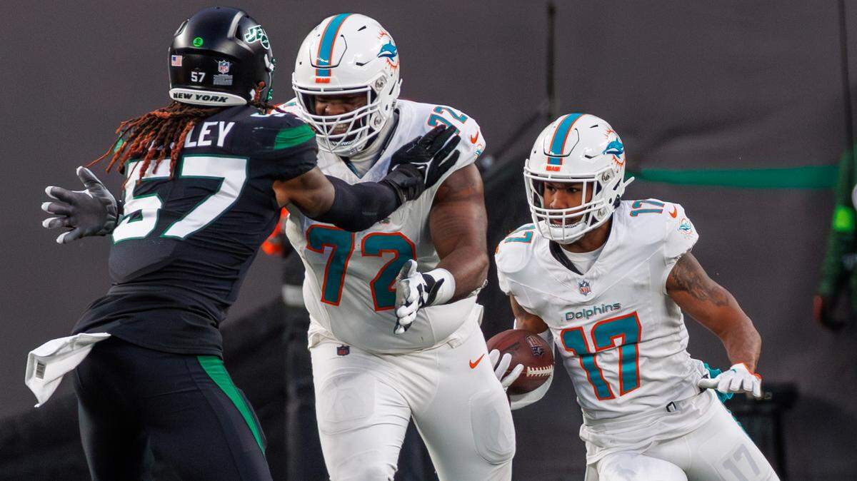 Miami Dolphins wide receiver Jaylen Waddle (17) runs with the football as Dolphins offensive tackle Terron Armstead (72) blocks New York Jets linebacker C.J. Mosley (57) during second quarter of an NFL football game at MetLife Stadium on Friday, Nov. 24, 2023 in East Rutherford, New Jersey.