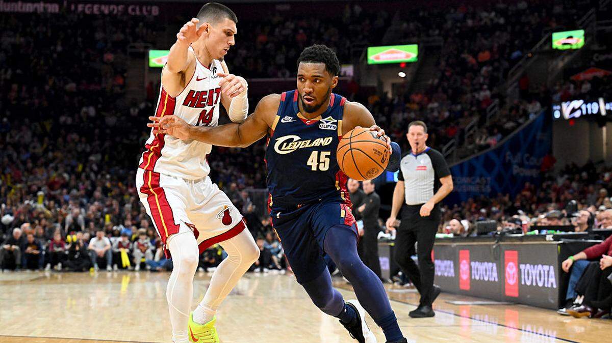 Donovan Mitchell #45 of the Cleveland Cavaliers drives to the basket around Tyler Herro #14 of the Miami Heat during the fourth quarter at Rocket Arena on March 27, 2026 in Cleveland, Ohio.