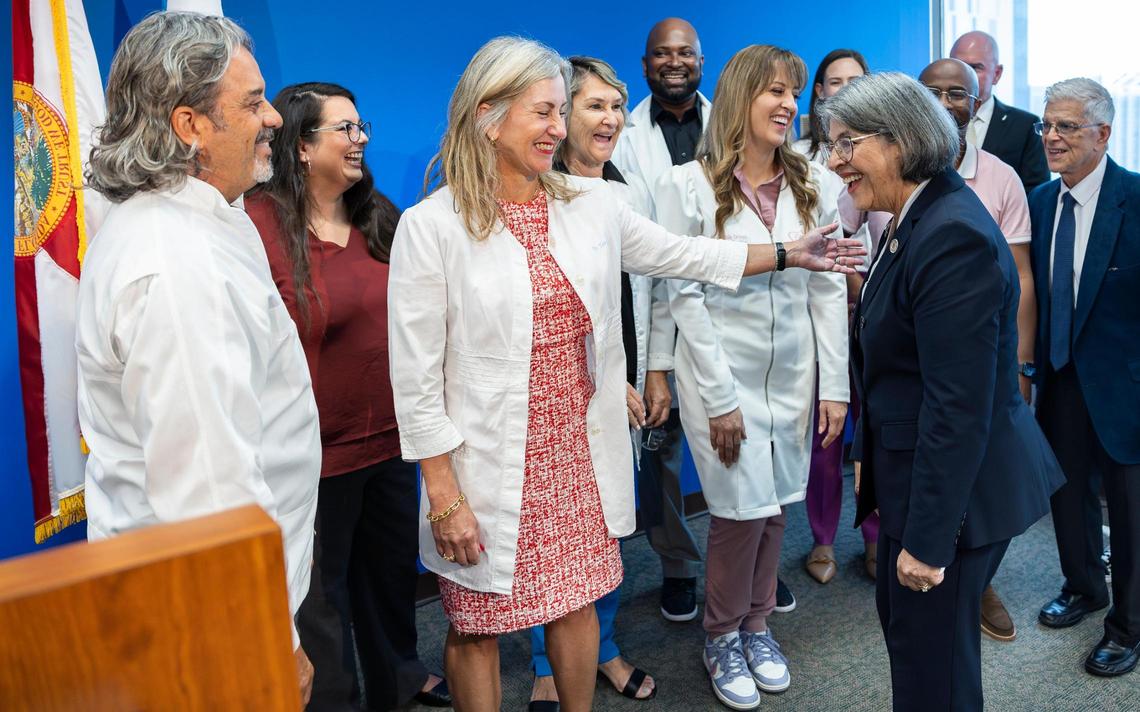 Dentist Beatriz E. Terry, center, reacts as Miami-Dade Mayor Daniella Levine Cava greets dentists who joined her during a press conference at the Stephen P. Clark Center on Friday, April 11, 2025, in downtown Miami, where Levine Cava announced she would veto legislation that would end the county’s practice of adding fluoride to drinking water.