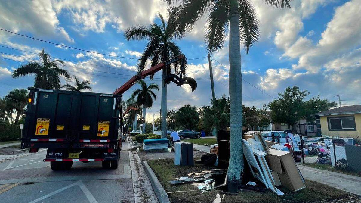City of Naples trucks pick up water-damaged furniture and mattresses at the east side of Naples’ River Park neighborhood on Oct. 1. Hurricane Ian’s storm surge caused many single-family homes in the area to flood on Sept. 27.