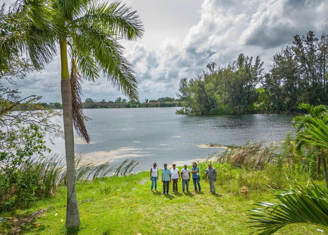 A group of neighbors in the Little River Farms neighborhood stand by the shore of Silver Blue Lake, where a developer wants to build apartment complexes. They were photographed on Tuesday August 29, 2023.