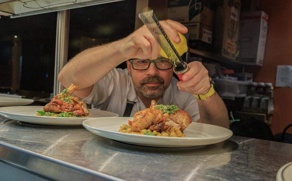 Victor Santos, chef/owner finishes up a boneless half chicken, a dish on the menu of the recently opened Tin Tin, Cuban Cuisine Restaurant in Little Havana, on Friday January 09, 2026.