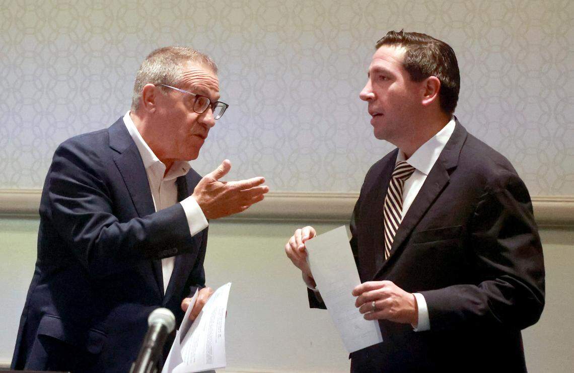 Central Florida Tourism Oversight District Board of Supervisors chairman Martin Garcia, left, consults with board member Brian Aungst, Jr., before the passing of a resolution to invalidate Disney’s final agreement with the previous board —the Reedy Creek Improvement District— Wednesday, April 26, 2023, in Lake Buena Vista, Fla. Florida Gov. Ron DeSantis handpicked the new board in an ongoing dispute with Disney Co. over who controls the special taxing district that manages the municipal infrastructure at Walt Disney World. (Joe Burbank/Orlando Sentinel via AP)