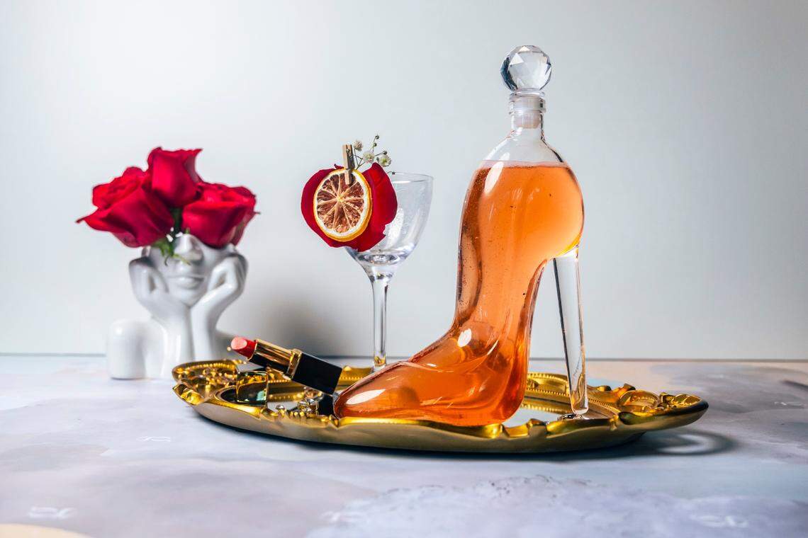 The Head Over Heels cocktail, served in a glass stiletto, is intended to be shared and combines E11even vodka, sparkling rose, raspberry, lemongrass and citrus.