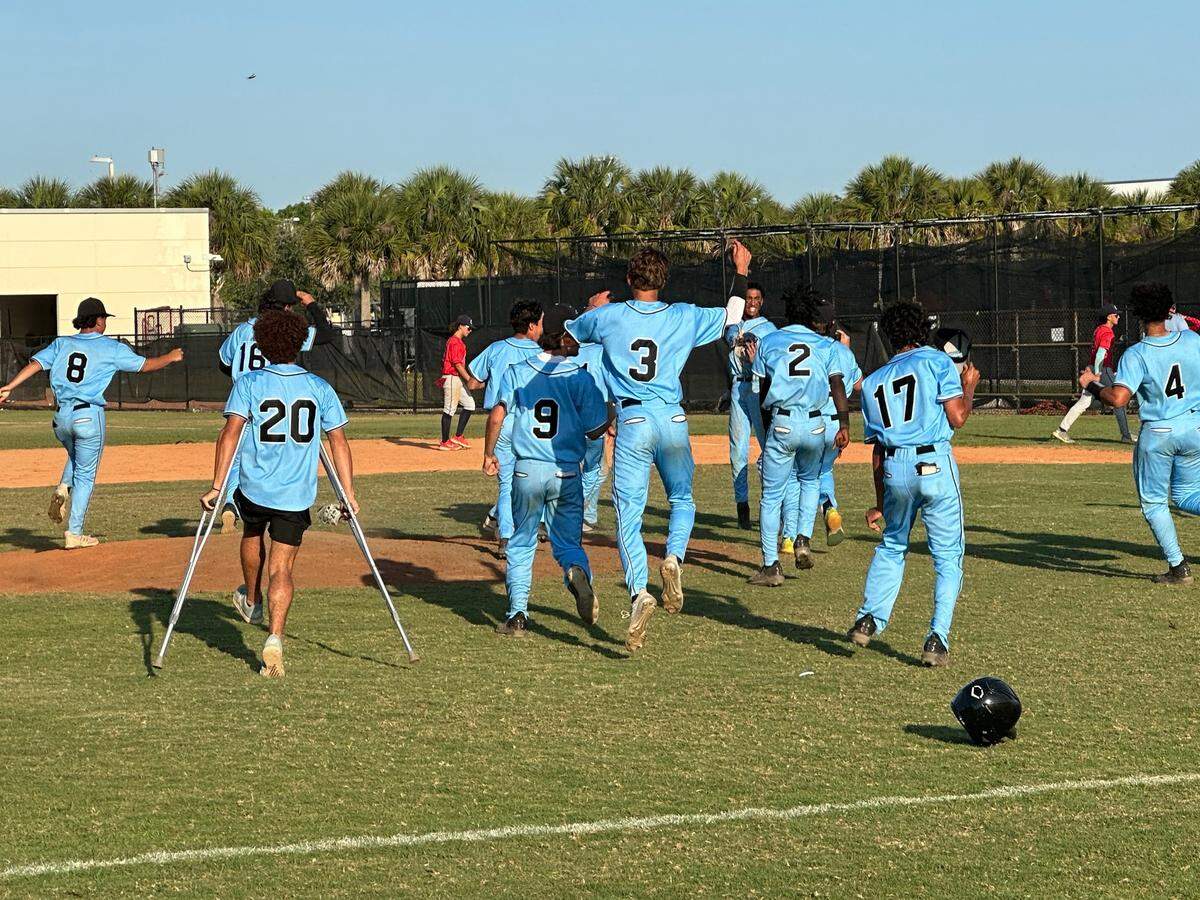 West Broward players storm the mound at their home field after their 7-6 walk-off win over Columbus on Friday in a Region 4-7A semifinal.