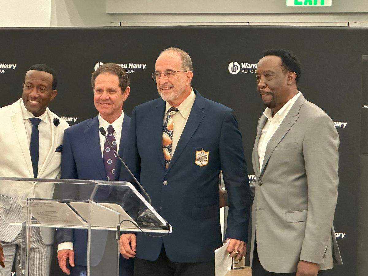 Legendary former Miami Southridge coach Don Soldinger (middle) is honored with the Warren Henry Auto Hall of Fame Coaches award during a ceremony on Wednesday night at the Warren Henry Auto dealership in North Miami Beach.