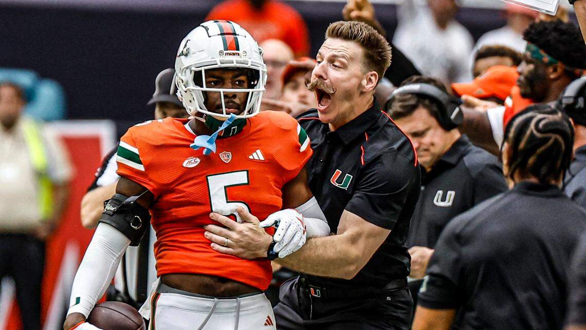 Miami Hurricanes strength and conditioning coach Aaron Feld reacts after safety Kamren Kinchens (5) intercepts a Louisville Cardinals pass in the first quarter on Saturday, November 18, 2023.