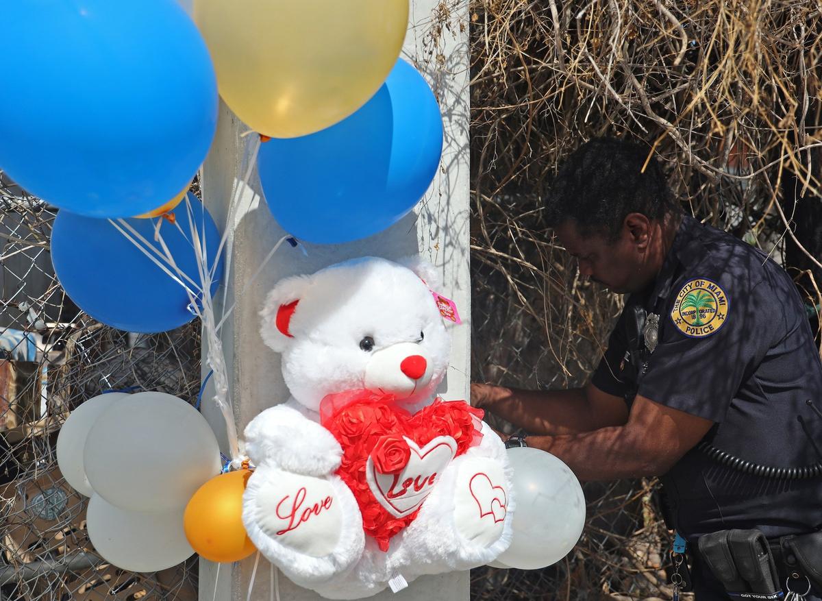 Miami Police officer James Fraser, right, helps tie balloons in memory Richard Lindsay at the site where his body was found in a green sedan on Tuesday, Feb. 12, 2019. Members of Florida Parents of Murdered Children, concerned citizens and local police officers stood together in remembering the first anniversary of the Marjory Stoneman Douglas mass shooting on Thursday, Feb. 14, 2019.