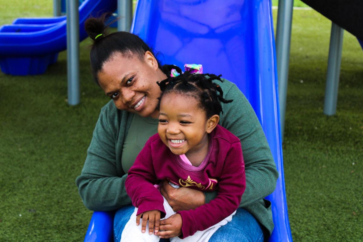 Cliffvonia Rigby and her daughter Elizabeth Rigby on a slide at Claude Pepper Park in North Miami.