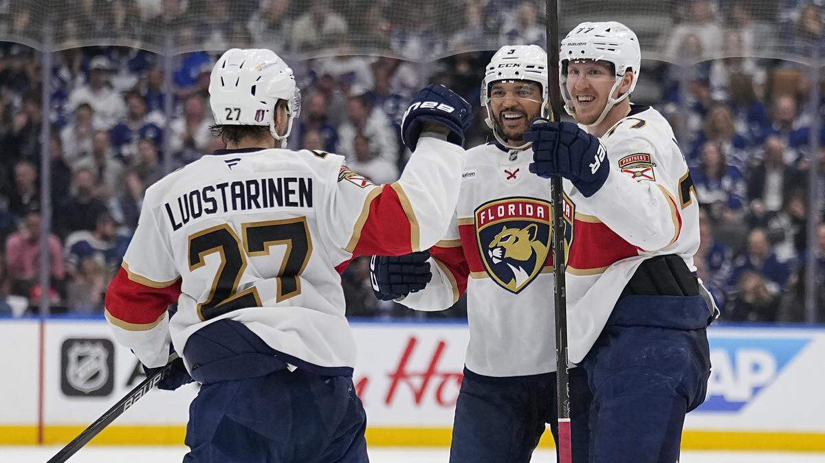 May 14, 2025; Toronto, Ontario, CAN; Florida Panthers forward Eetu Luostarinen (27) and defenseman Seth Jones (3) congratulate defenseman Niko Mikkola (77) on his goal against the Toronto Maple Leafs during the second period of game five of the second round of the 2025 Stanley Cup Playoffs at Scotiabank Arena.