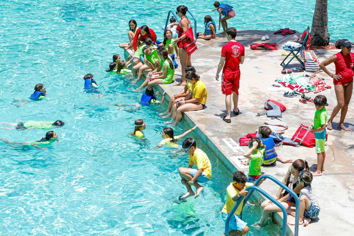 Summer campers enjoy the afternoon swimming and cooling down by the water at the Venetian Pool in Coral Gables, Florida, on Monday, June 13, 2022.