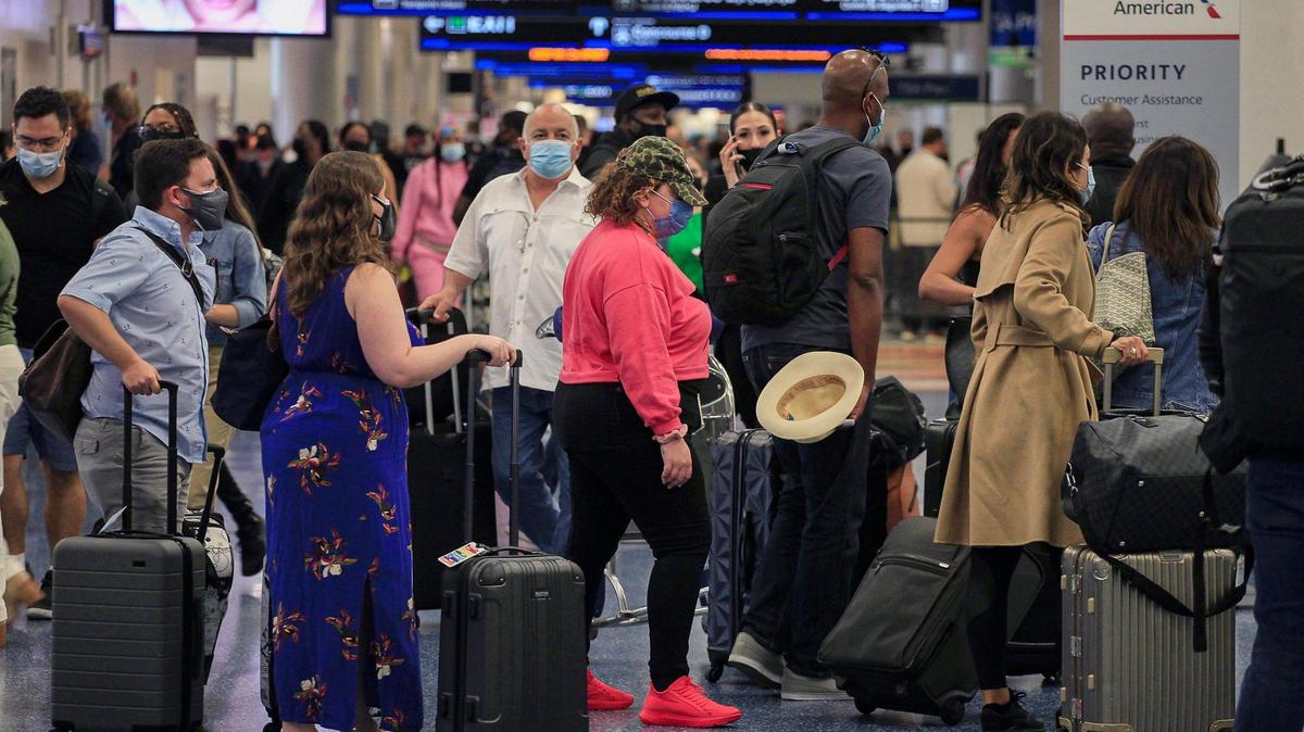Travelers line-up as they check-in at the crowded American Airlines ticket counter. On Monday, April 12, 2021 thousands of desperate passengers were left stranded at Miami International Airport Sunday after their flights were canceled because of stormy weather, according to airport officials.