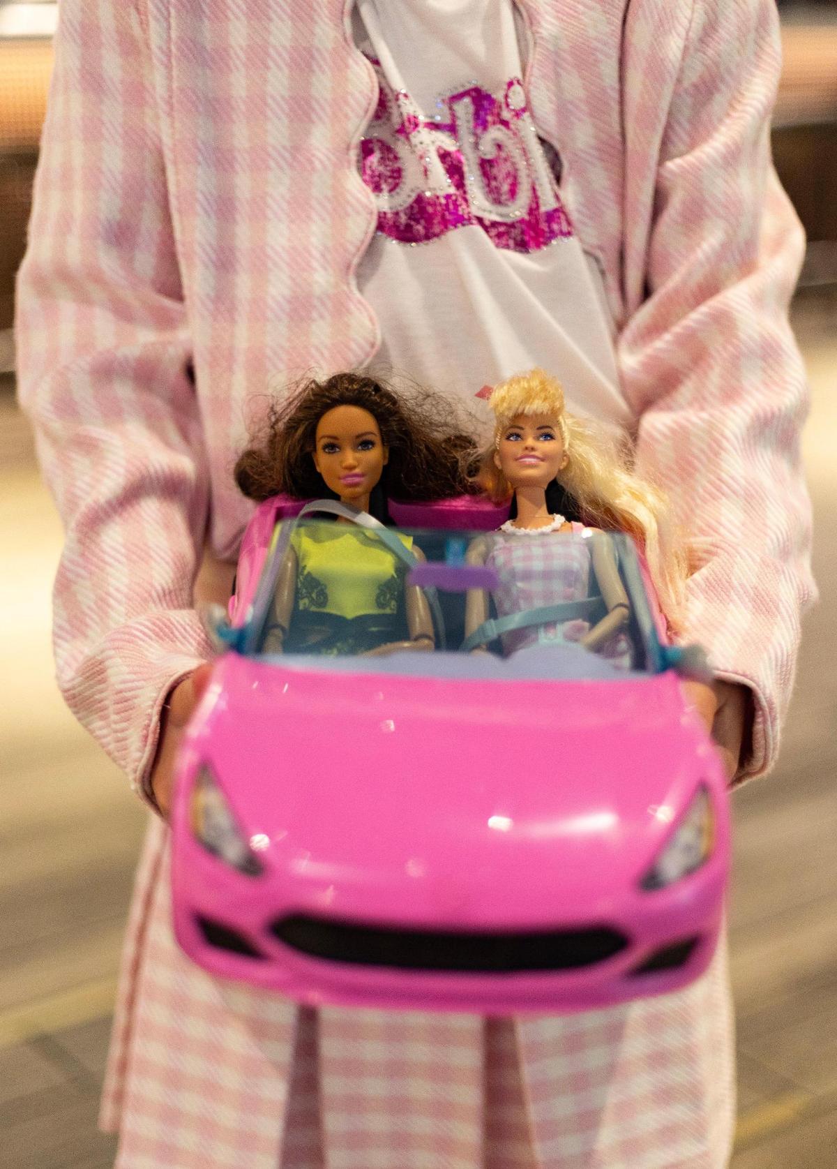 Mila Boucher, 9, shows off her dolls in their hot pink convertible inside Cinépolis Coconut Grove before seeing the Barbie movie in Miami, Fla., on Sunday, July 23, 2023.