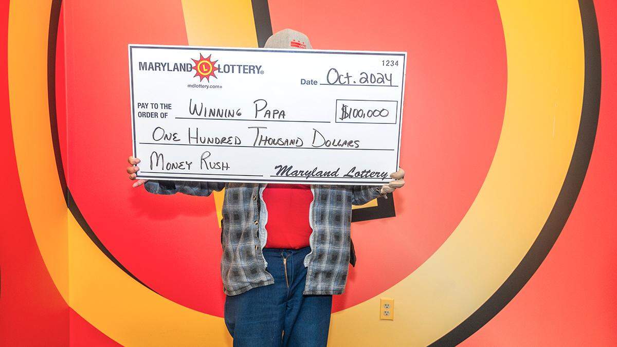 Winning Papa poses with his $100,000 top-prize win.