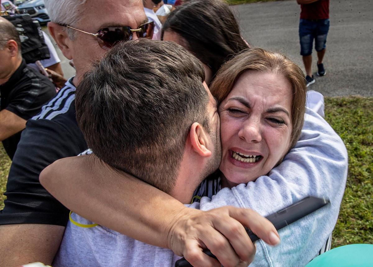 Detainee Jose Enrique Bernal is welcomed by his mother Gladys Castillo and stepfather Rolando Diaz, on Thursday, Dec. 29, 2022, after being released from the Broward Transitional Center in Pompano. He was among several Cuban detainees whose data was leaked last month that the U.S. government shared with Cuban authorities.