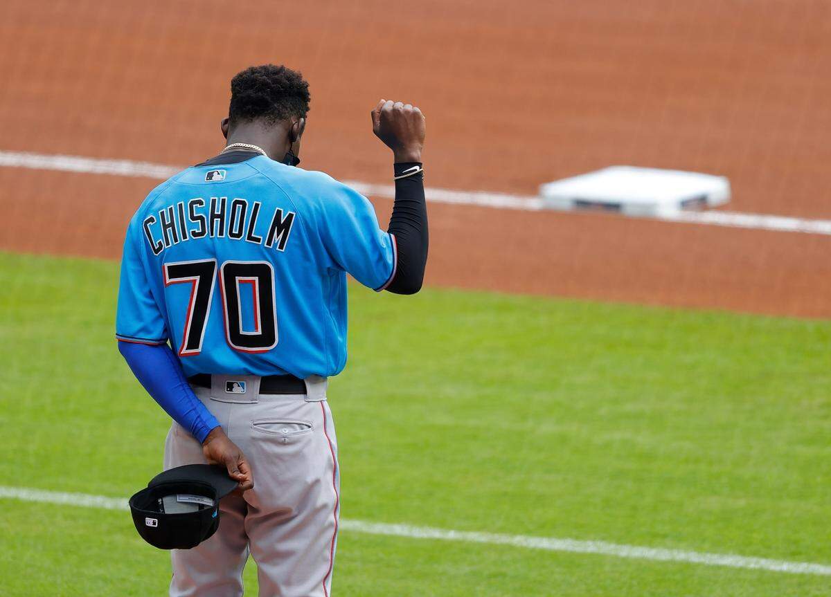 ATLANTA, GEORGIA - JULY 22: Jazz Chisholm #70 of the Miami Marlins holds his right fist up during the National Anthem prior to an exhibition game against the Atlanta Braves at Truist Park on July 22, 2020 in Atlanta, Georgia. (Photo by Kevin C. Cox/Getty Images)