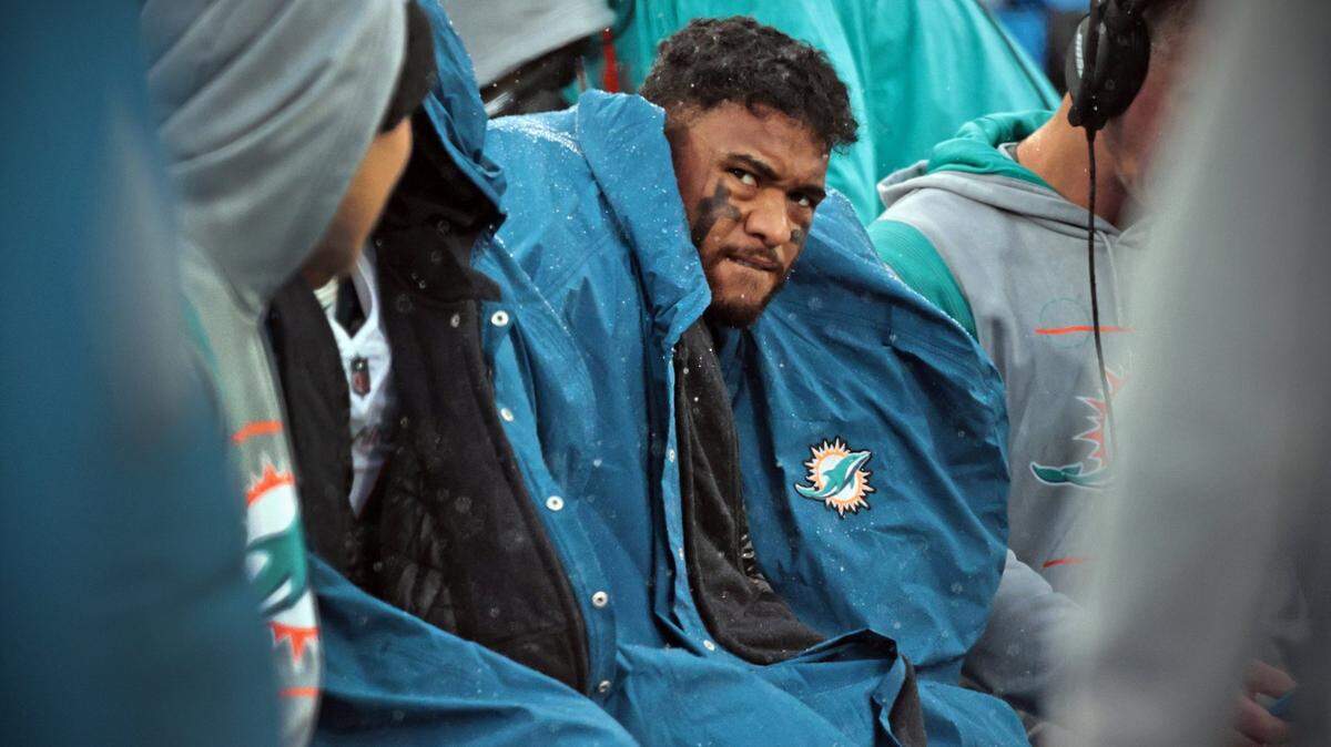 Miami Dolphins quarterback Tua Tagovailoa (1) sits on the bench as the Tennessee Titans lead in the fourth quarter at Nissan Stadium in Nashville, Tennessee on Sunday, January 2, 2022.