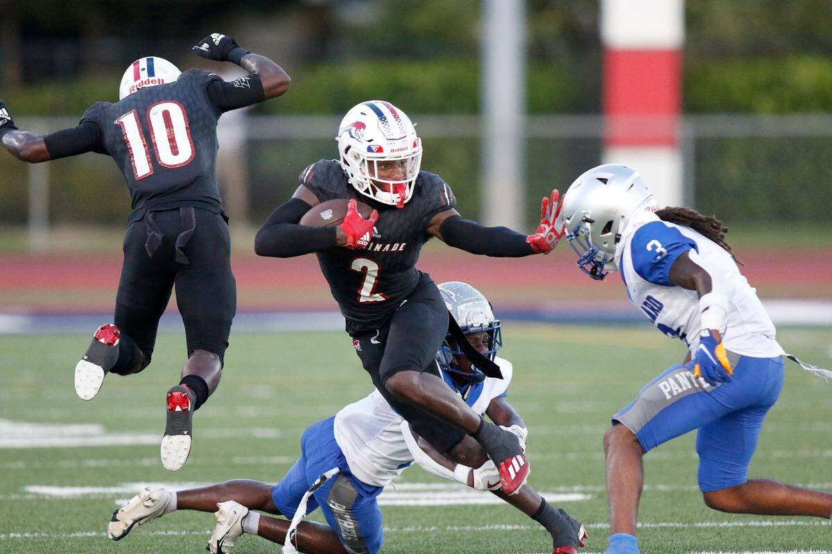 Chaminade-Madonna Lions wide receiver Edwin Joseph (2) tries to escape Dillard Panthers Tre’ Vaughn Martinez during football game on Friday, September 2, 2022 at Chaminade-Madonna HS in Hollywood. Andrew Uloza / for Miami Herald