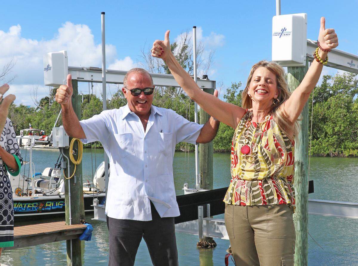 Rhonda Haag, Monroe County’s Director of Sustainability, on the right, celebrates with Roman Gastesi, Monroe County Administrator at the last canal being cleared on Thursday, Oct. 24, 2019.