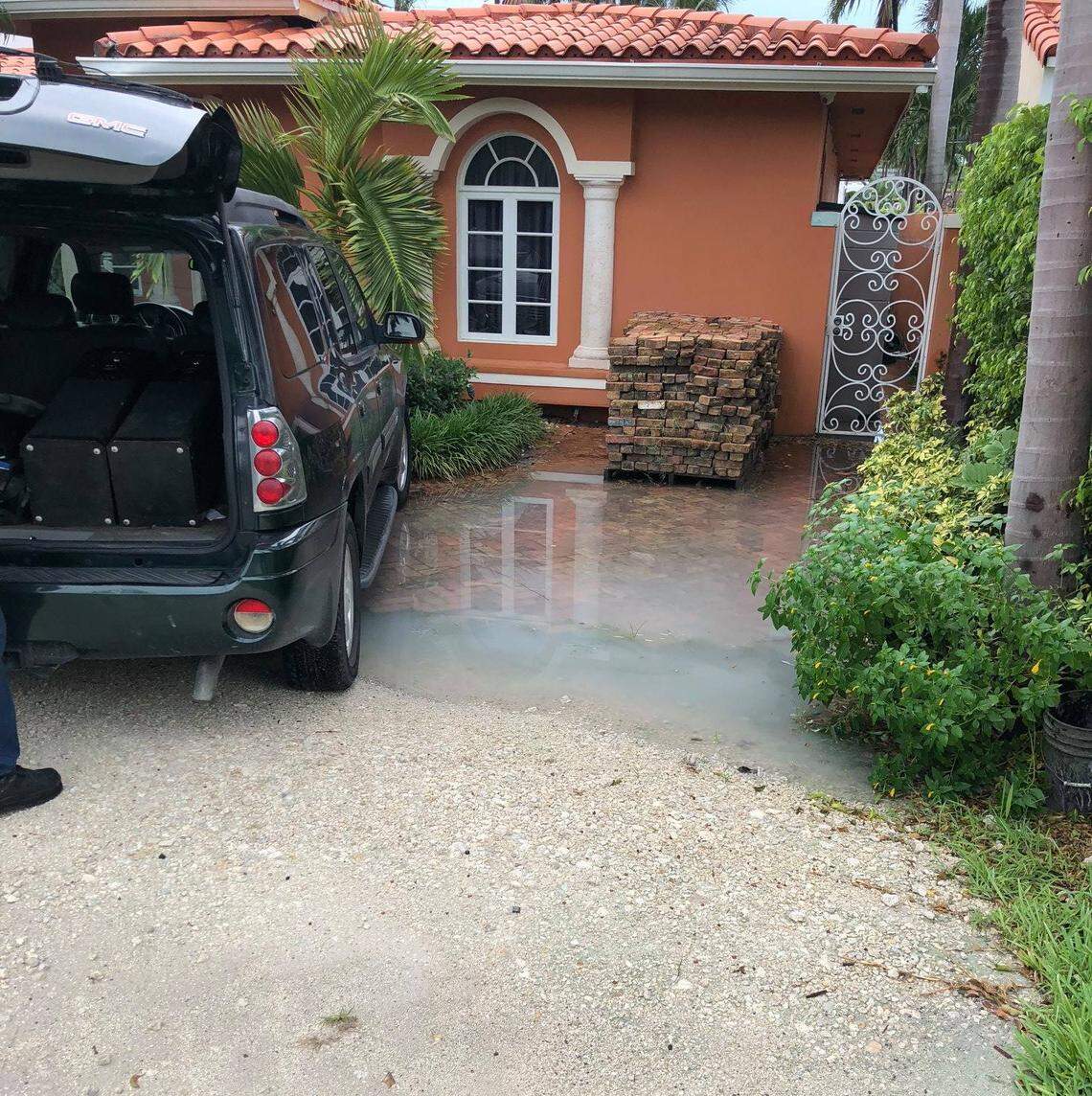 Andres Asion, a Miami Beach broker, photographed his parents’ home on Palm Island after a rainstorm. He blames the floodwaters puddling around their door on the newly elevated road that’s now a higher elevation than his parents’ front door.