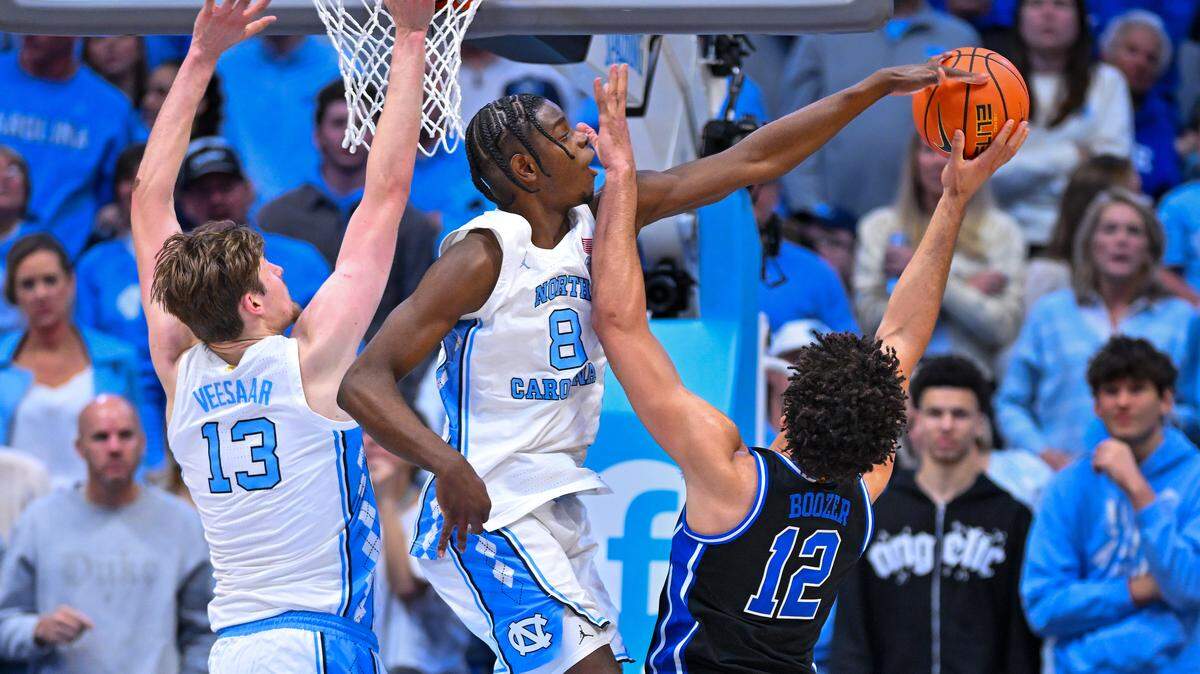 CHAPEL HILL, NORTH CAROLINA - FEBRUARY 07: Caleb Wilson #8 of the North Carolina Tar Heels blocks a shot by Cameron Boozer #12 of the Duke Blue Devils during the second half of the game at Dean E. Smith Center on February 07, 2026 in Chapel Hill, North Carolina. (Photo by Grant Halverson/Getty Images)