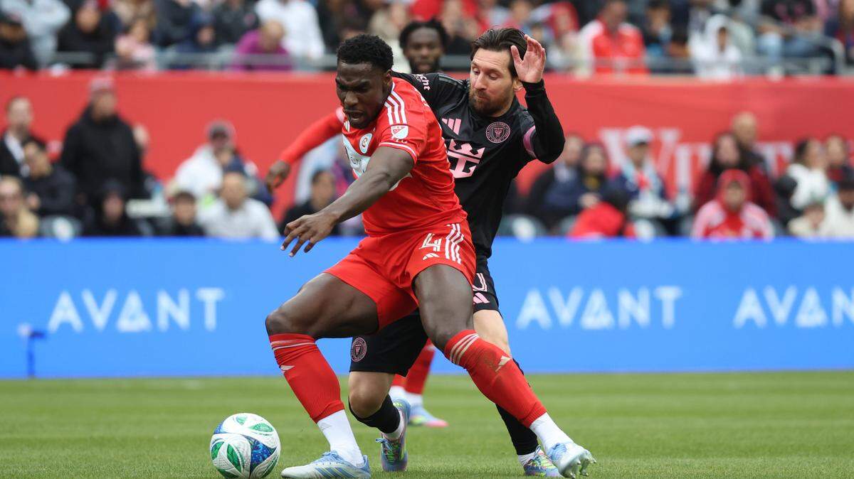 Apr 13, 2025; Chicago, Illinois, USA; Chicago Fire FC defender Carlos Tern (4) and Inter Miami CF forward Lionel Messi (10) battle for control of the ball during the first half at Soldier Field. Mandatory Credit: Talia Sprague-Imagn Images
