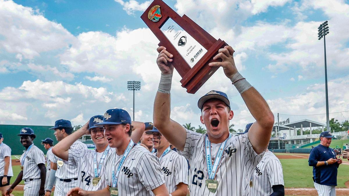 North Broward Prep Eagles Mateo Gray (22) celebrates lifts the state championship trophy after defeating the Westminster Christian School Warriors in the the FHSAA Baseball Class 3A State Final at Hammond Stadium in Fort Myers, Florida on Wednesday, May 22, 2024.