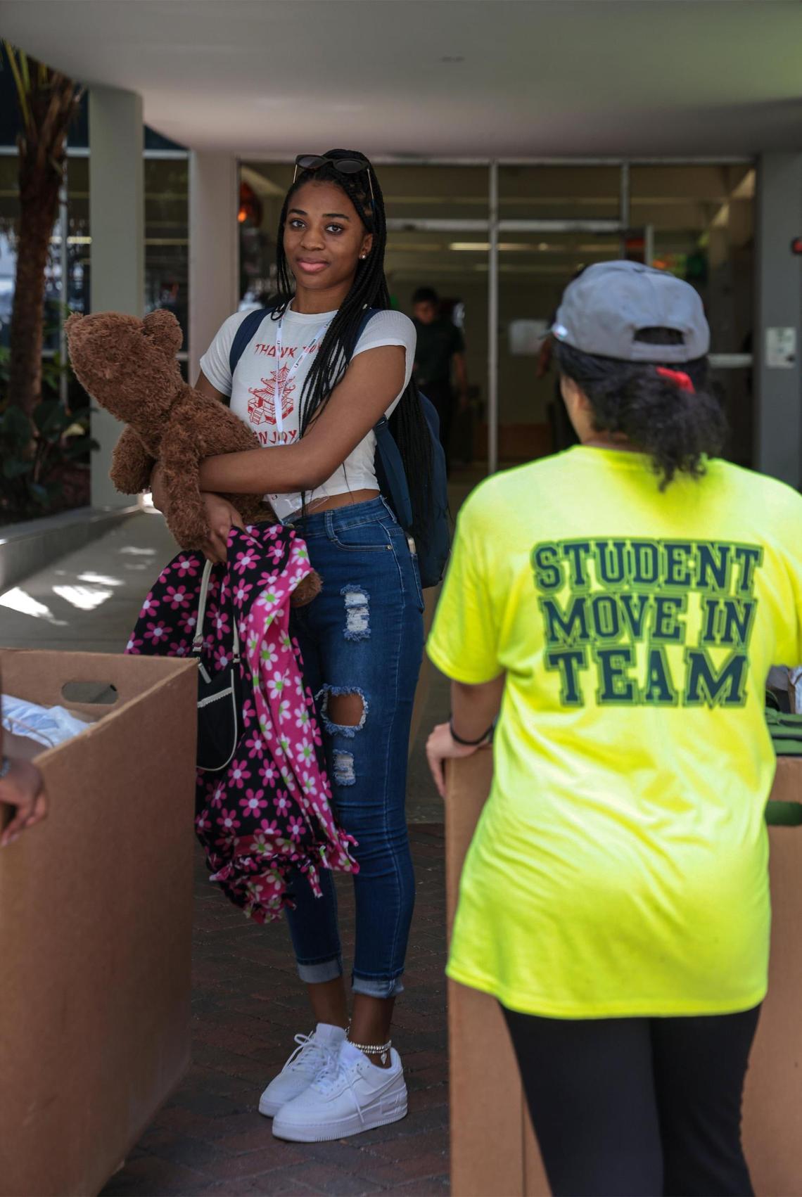 Freshman Ijenna Mere, 17, left, holds her teddy bear as she moves into her University of Miami dorm. On Tuesday, Aug. 16, 2022, out-of-state UM freshmen moved with their parents in tow into the Mahoney and Pearson residential colleges with help from the “Student Move in Team” by University and Student Services in Coral Gables, Florida.