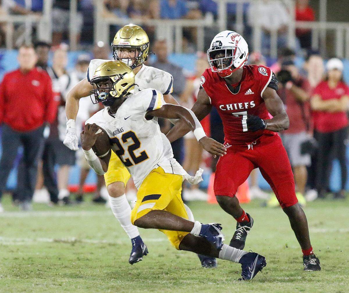 St Thomas Aquinas Raiders running back Gemari Sands (22) gains yardage during the football game against Cardinal Gibbons Chiefs on Saturday, October 16, 2021 at FAU Stadium in Boca Raton