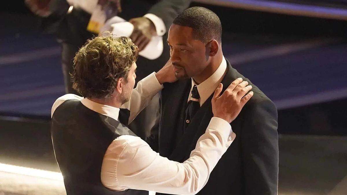Actor Bradley Cooper, left, talks to Will Smith after the “King Richard” actor slapped comedian Chris Rock.