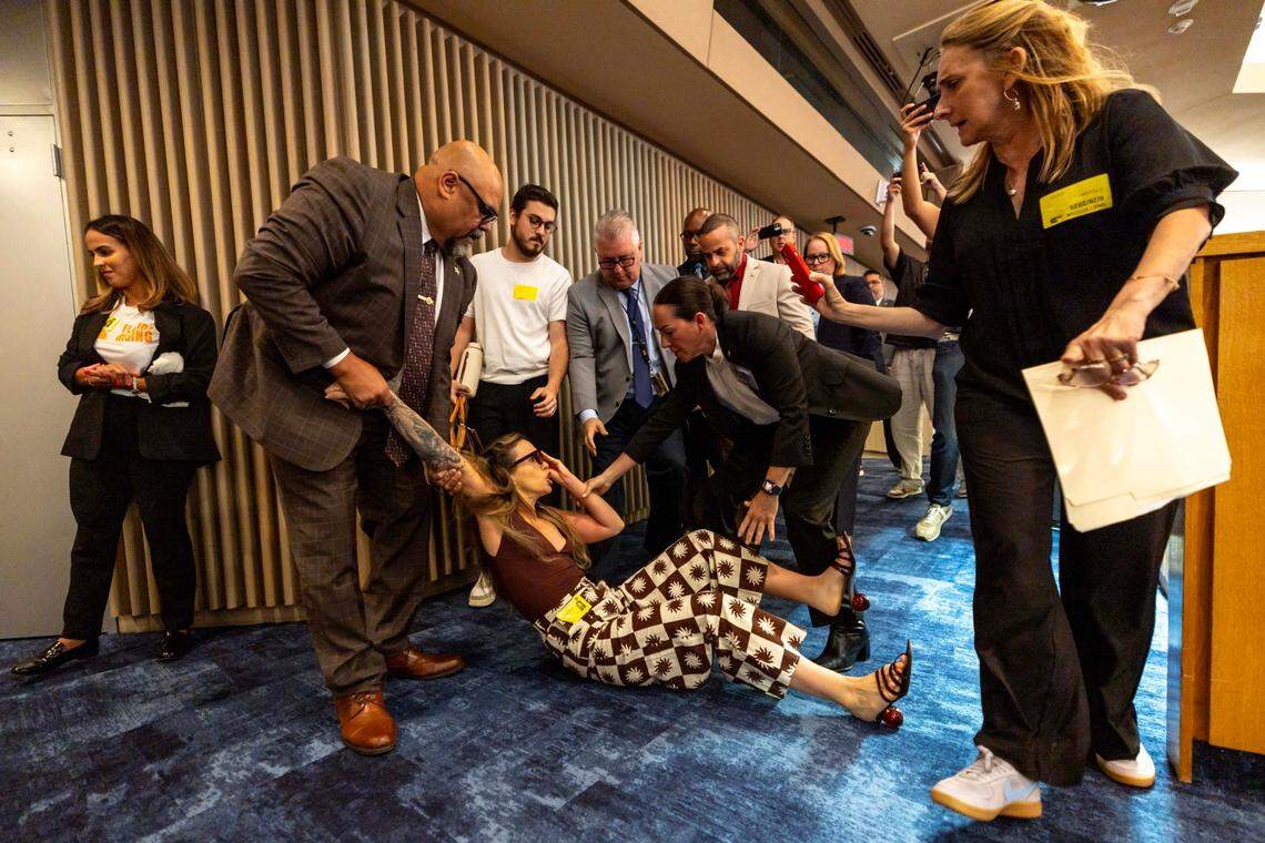 Camila Ramos is forcibly removed from the commission chambers by officers during a Miami-Dade County Commission meeting at the Stephen P. Clark Government Center on Thursday, June 26, 2025, in Miami.