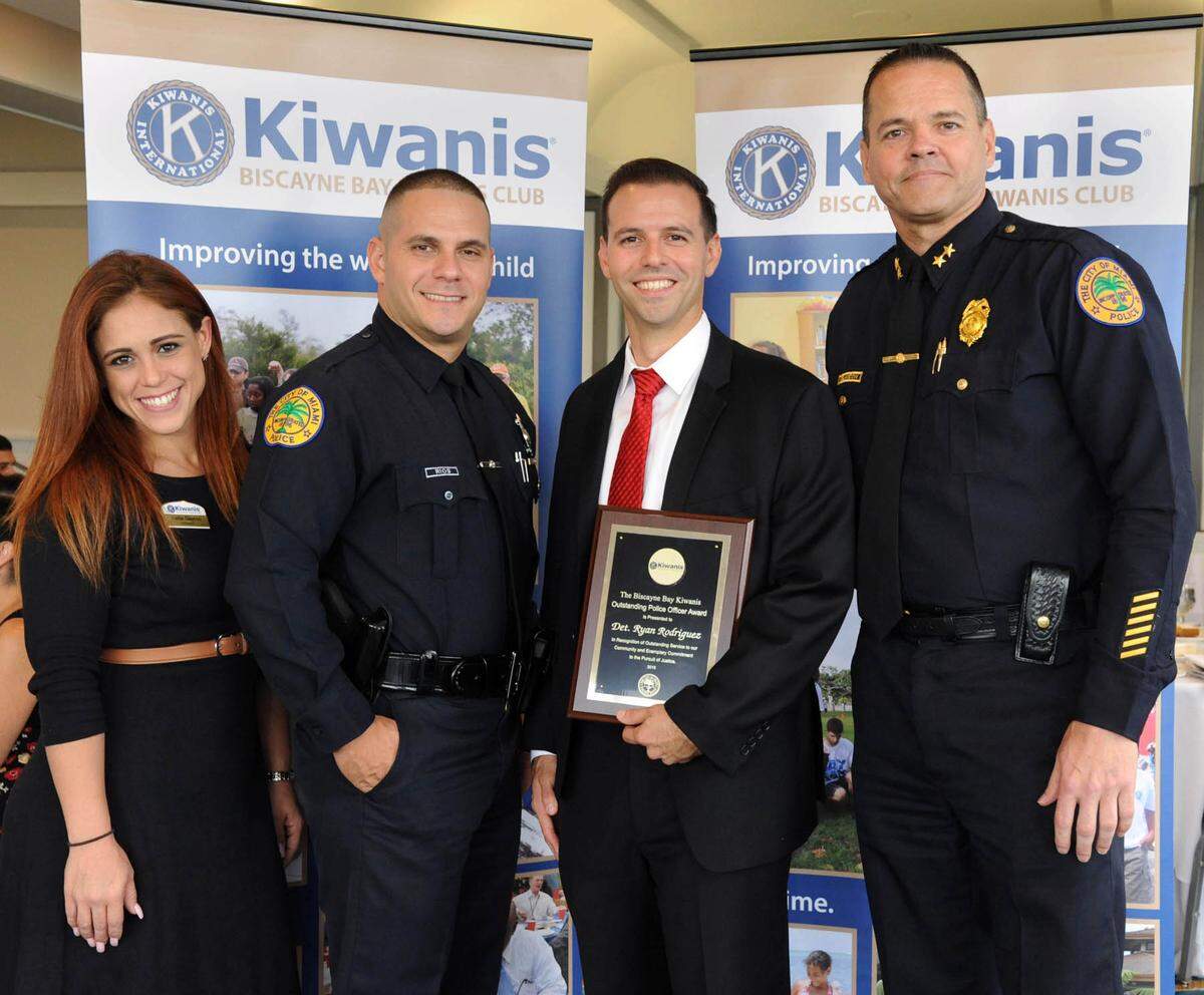 Miami Detective Doug Rodriguez, holding plaque, was named the winner of Biscayne Bay Kiwanis Club’s 2018 Police Officer of the Year award. Rodriguez is pictured with Kellie Gayoso, president of the Biscayne Bay Kiwanis Club; Richard Rios, 2017 Officer of the Year; and Louis Melancon, assistant police chief.