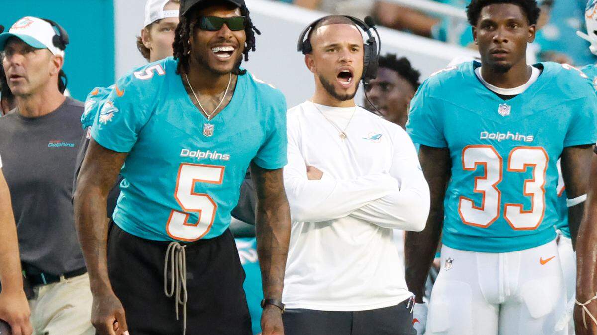 Miami Dolphins cornerback Jalen Ramsey (5) and cornerback Siran Neal (33) react on the sidelines during the game against the Washington Commanders at Hard Rock Stadium in Miami Gardens, Florida on Saturday, August 17, 2024.