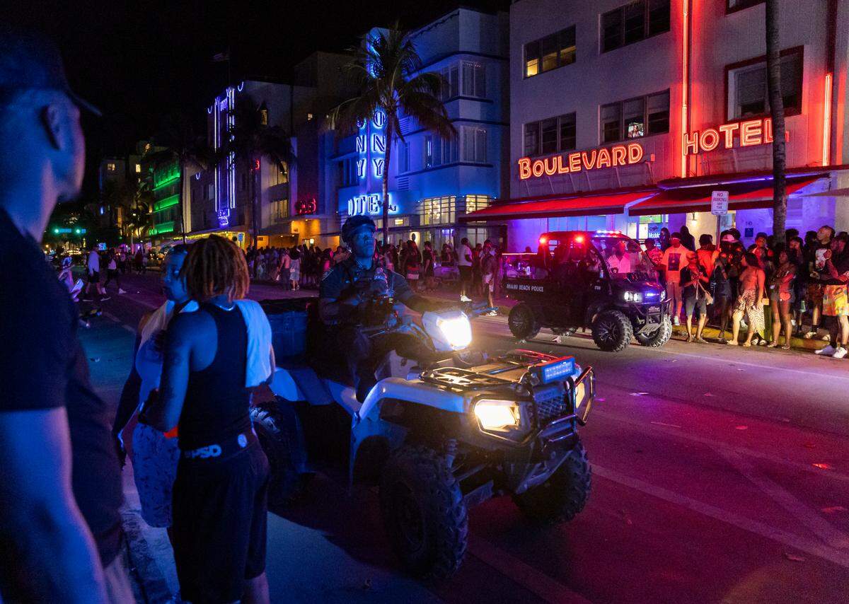 Police work to disperse a large crowd and reopen traffic on Ocean Drive during spring break on Saturday, March 11, 2023, in Miami Beach, Fla.
