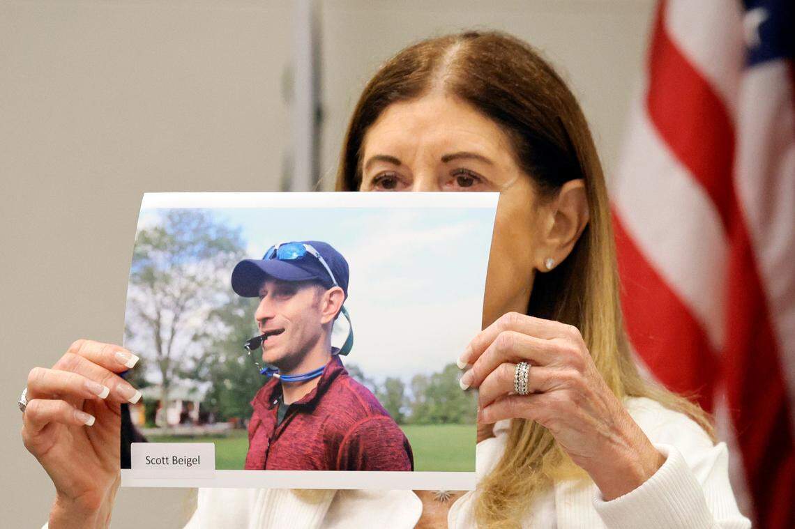 Linda Beigel Schulman holds a photograph of her son, Scott Beigel, before giving her victim impact statement during the trial of Marjory Stoneman Douglas High School shooter Nikolas Cruz at the Broward County Courthouse.