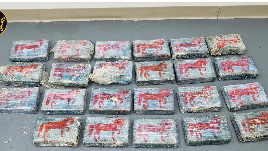 Twenty-three packages of cocaine weighing about 63 pounds are laid out for a photo released by the U.S. Border Patrol Wednesday, May 26, 2021. The drugs were found washed ashore in a state park in the Florida Keys the day before.