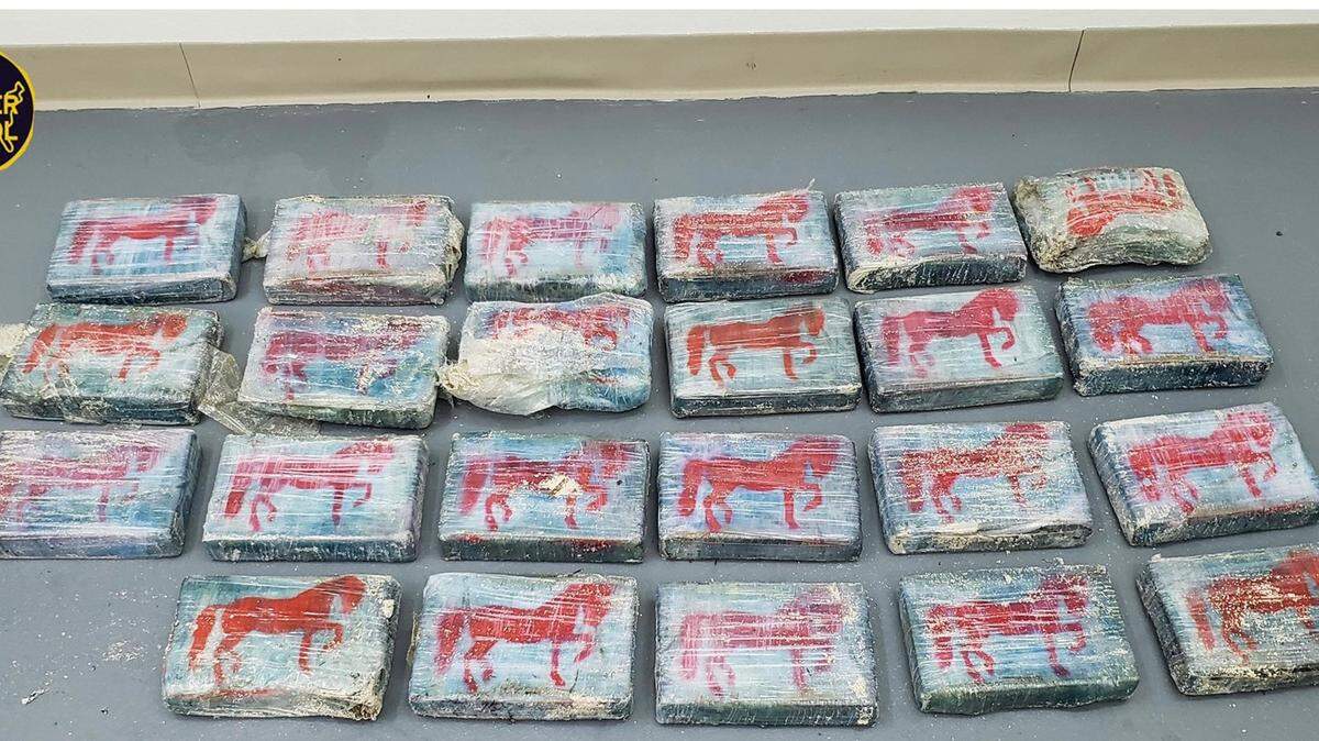 Twenty-three packages of cocaine weighing about 63 pounds are laid out for a photo released by the U.S. Border Patrol Wednesday, May 26, 2021. The drugs were found washed ashore in a state park in the Florida Keys the day before.