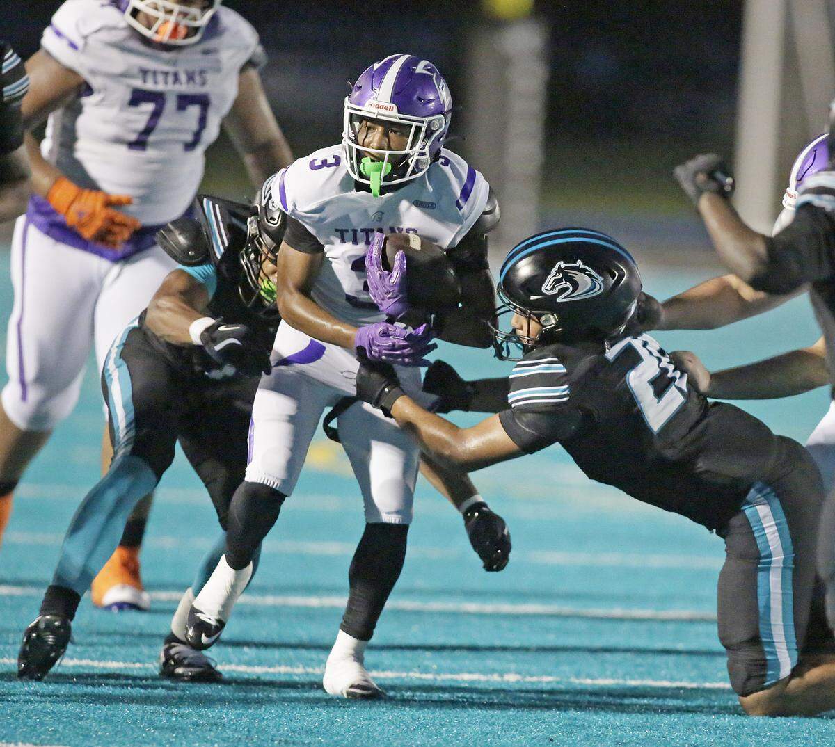 True North Titans running back Kemari Morrison (3) tries to escape a tackle by Archbishop McCarthy Mavericks defenders during the football game on Friday, September 12, 2025 at Archbishop McCarthy HS in Southwest Ranches. Andrew Uloza / for Miami Herald