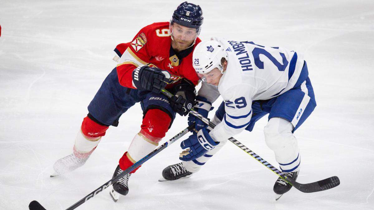 Florida Panthers center Sam Bennett (9) tries to keep the puck from Toronto Maple Leafs right wing Pontus Holmberg (29) during the third period of a hockey game on Tuesday, April 16, 2024, at Amerant Bank Arena in Sunrise, Fla. The Florida Panthers won 5-2.