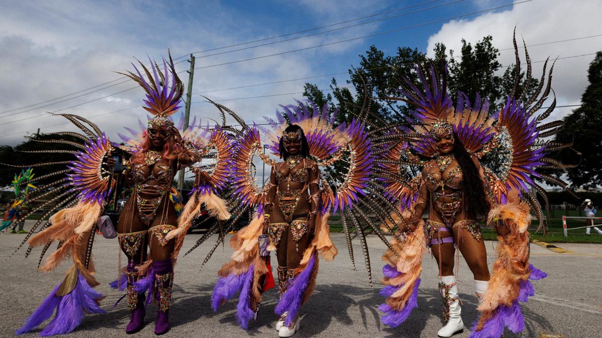 Three sisters masquerade before the Parade of Bands at Miami Carnival on Sunday, Oct. 13, 2024, at Miami-Dade County Fair Expo.