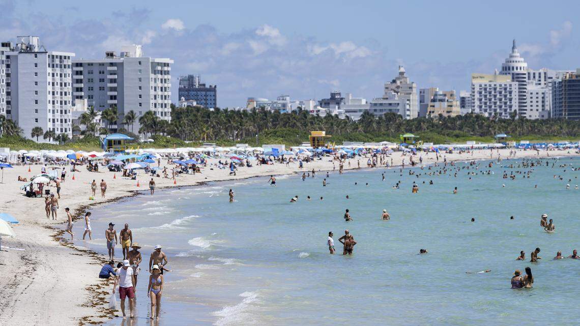 People visit South Beach as hot weather moves through the area on Friday, Aug. 15, 2025, in Miami Beach, Fla. Forecasters have issued heat advisories throughout the summer in South Florida, with temperatures at times feeling as hot as 109 degrees.