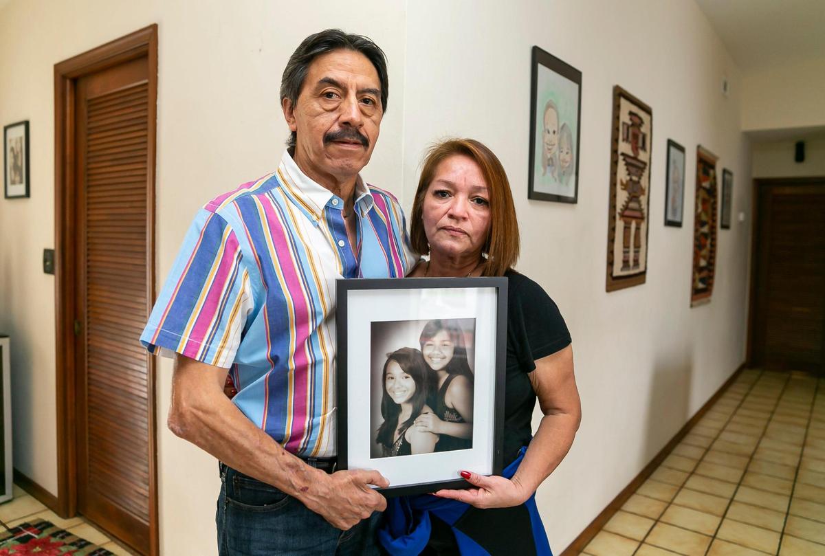 Gina and Orlando Duran hold a photo of their daughters, Dina and Alexa, at their home in northwest Miami-Dade, on Tuesday, Jan. 4, 2022. Alexa Duran, 18, was driving her father’s car the day the FIU bridge collapsed. She was one of six people who died in the collapse.