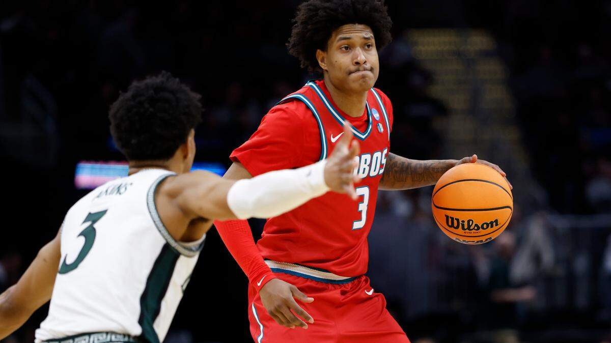 Mar 23, 2025; Cleveland, OH, USA; New Mexico Lobos guard Tru Washington (3) dribbles defended by Michigan State Spartans guard Jaden Akins (3) in the second half during the NCAA Tournament Second Round at Rocket Arena. Mandatory Credit: Rick Osentoski-Imagn Images
