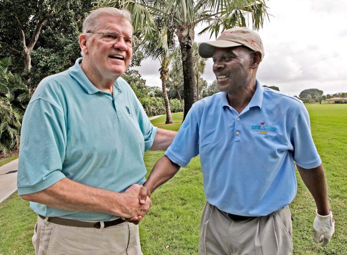 12.14.2007 -- JOHN VANBEEKUM / MIAMI HERALD -- Wide Receiver Marlin Briscoe, right, greets offensive line coach Monte Clark, left. Both are Dolphins ’72 alumni. Miami Dolphin teammates from the 1972 perfect season gathered Friday at the Doral Country Club and Spa to play golf as part of a week-long reunion which culminates with Sunday’s Celebration of Perfection at the Dolphin-Ravens game.