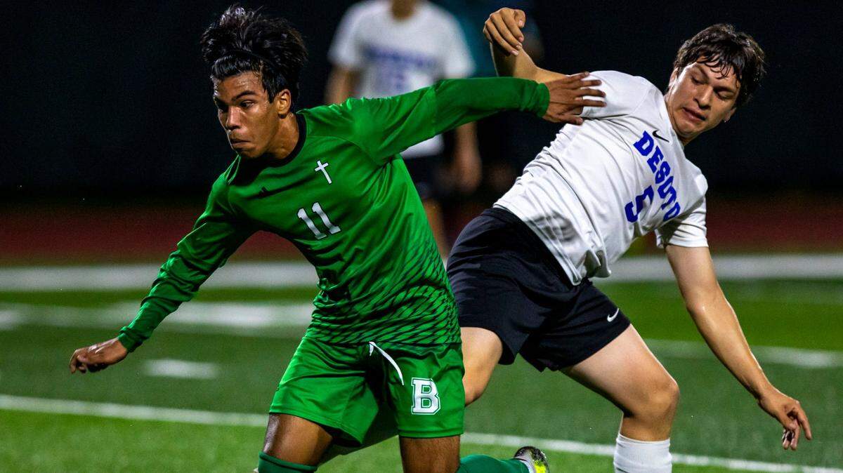 St. Brendan forward Danny Reyes (3) fights for possession of the ball with DeSoto County defender Jonathan Mar (5) during the Class 4A soccer state semifinal in Miami, Florida, on Saturday, February 19, 2022.
