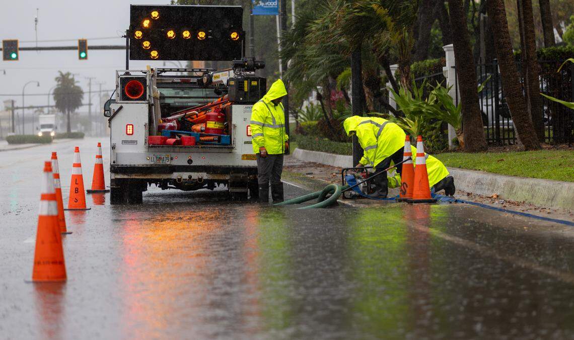 City of Hollywood workers install a temporary water pump in a flooded area near South Ocean Drive and Azalea Terrace on Monday, May 12, 2025, in Hollywood, Florida. The National Weather Service in Miami forecasts widespread showers and thunderstorms throughout the day, with a 90% chance of rain and expected rainfall totals between 1 to 3 inches through Tuesday morning.