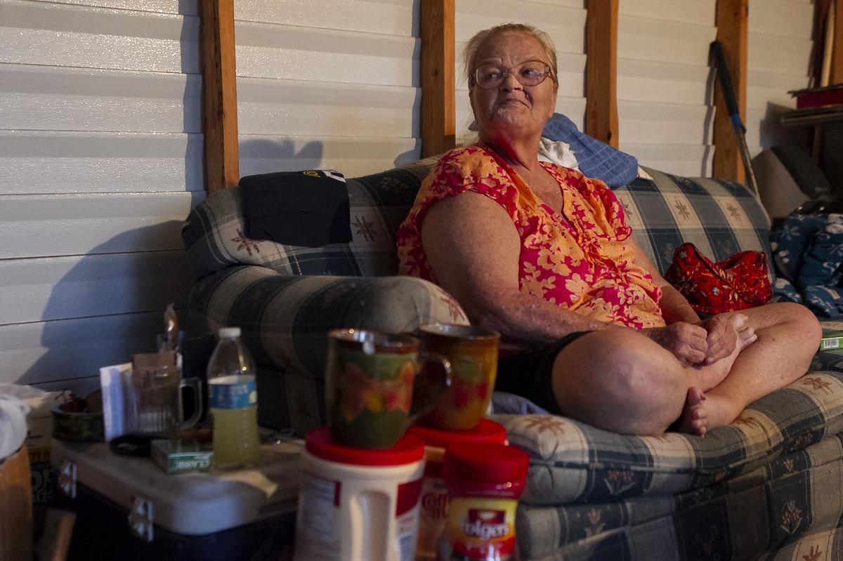 Brigetti Fox sits on a couch in a shed she now shares with her husband, Mickey Fox, in Callaway, Florida, on Saturday, Oct. 20, 2018. The couple survived Hurricane Michael in a trailer that collapsed on top of them.